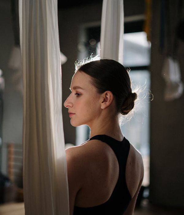 Woman in a fluid yoga pose, demonstrating flexibility and calm.